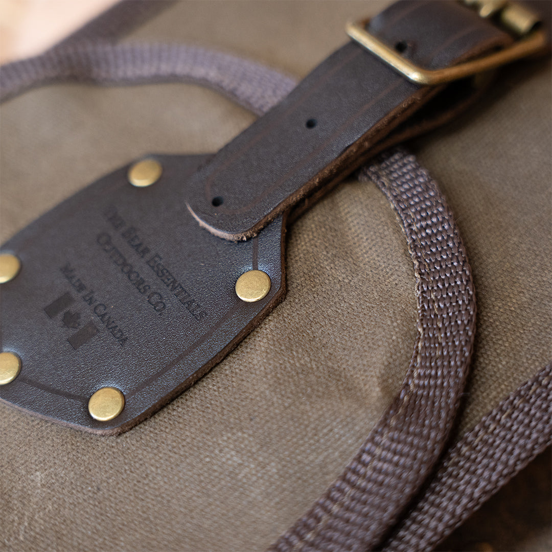 Detail of leather patch and rivets on Clearance: Carrying Sling for Saws and Axes, emphasizing Canadian-made hardware quality.