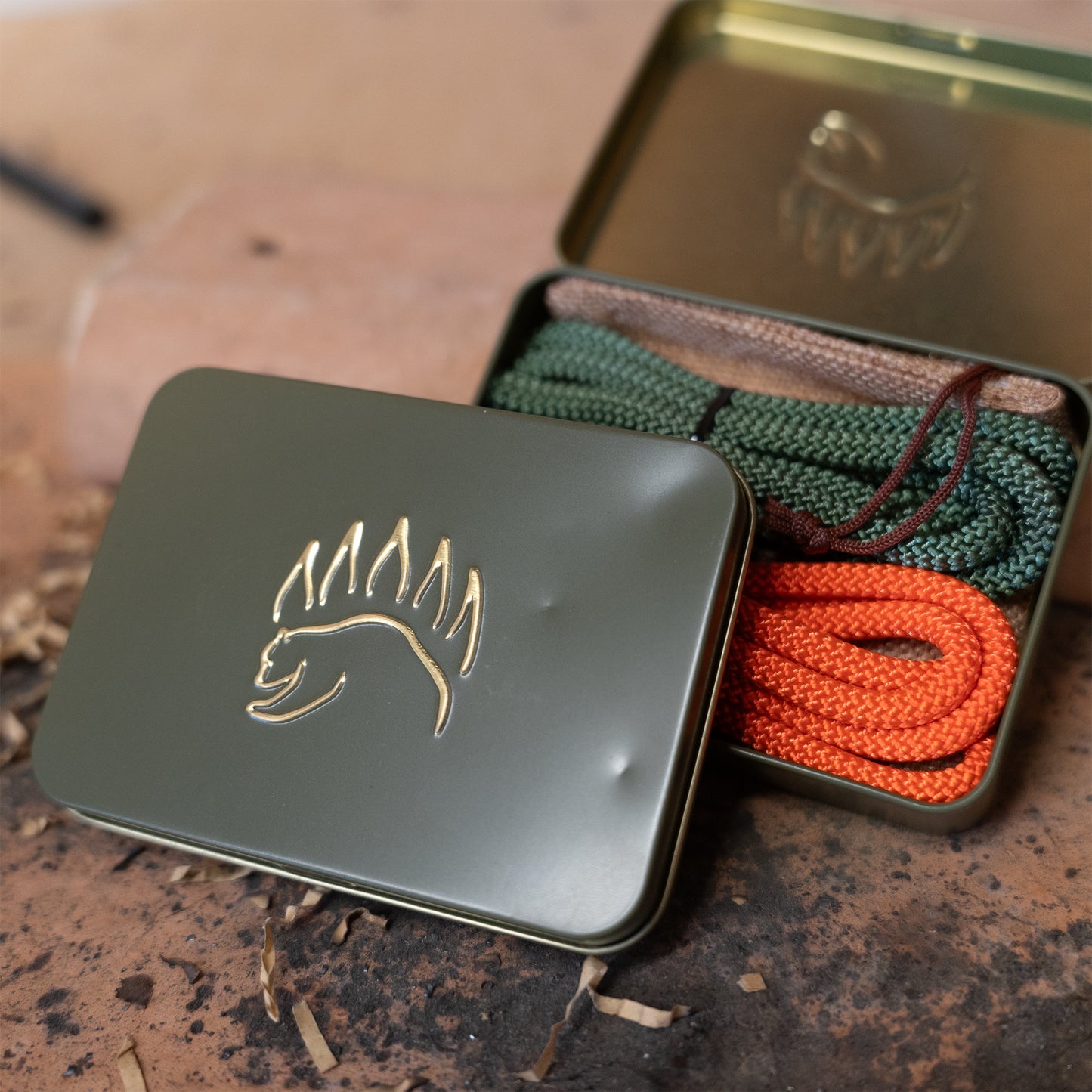 Clearance knot tying kit with visible tin imperfections, includes colorful ropes and instructional cards for camping knots.