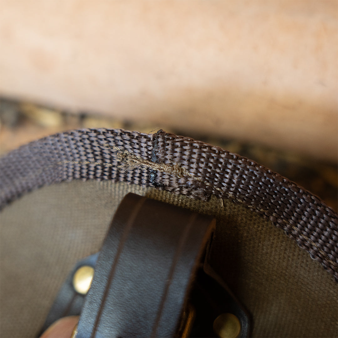 Frayed stitching on webbing of Clearance: Carrying Sling for Saws and Axes, highlighting minor wear in this clearance axe accessory.