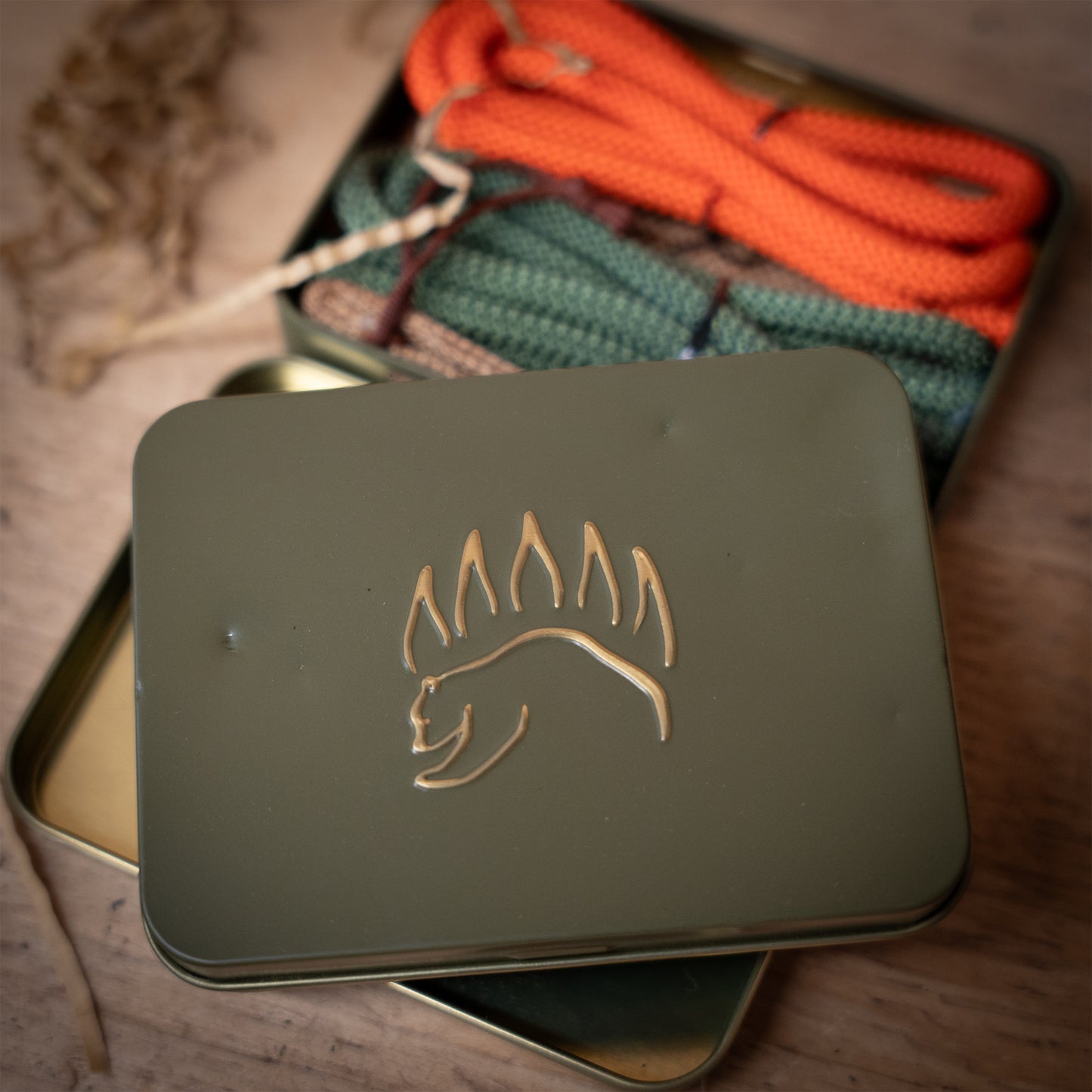 Camping Knots Edition of The Bear Essentials Knot Tying Kit LARGE in a dented green tin with embossed bear paw logo, part of clearance sale.