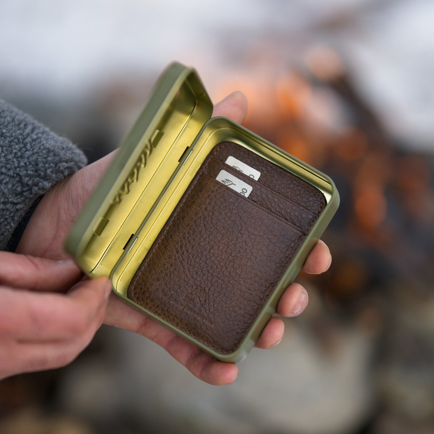 Brown leather Field Sharpener Wallet with dual grit plates stored in a green tin case, perfect for field use and EDC sharpening.