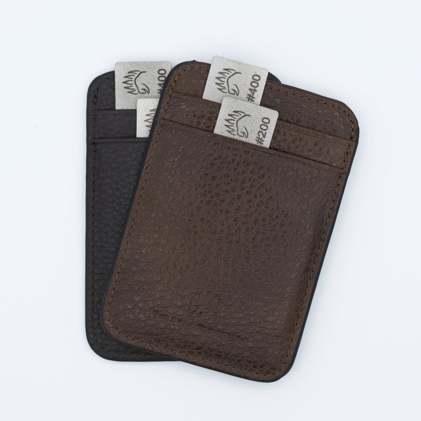Two Field Sharpener Wallets in brown and black leather, each holding dual grit sharpening plates #200 and #400 for versatile blade maintenance.