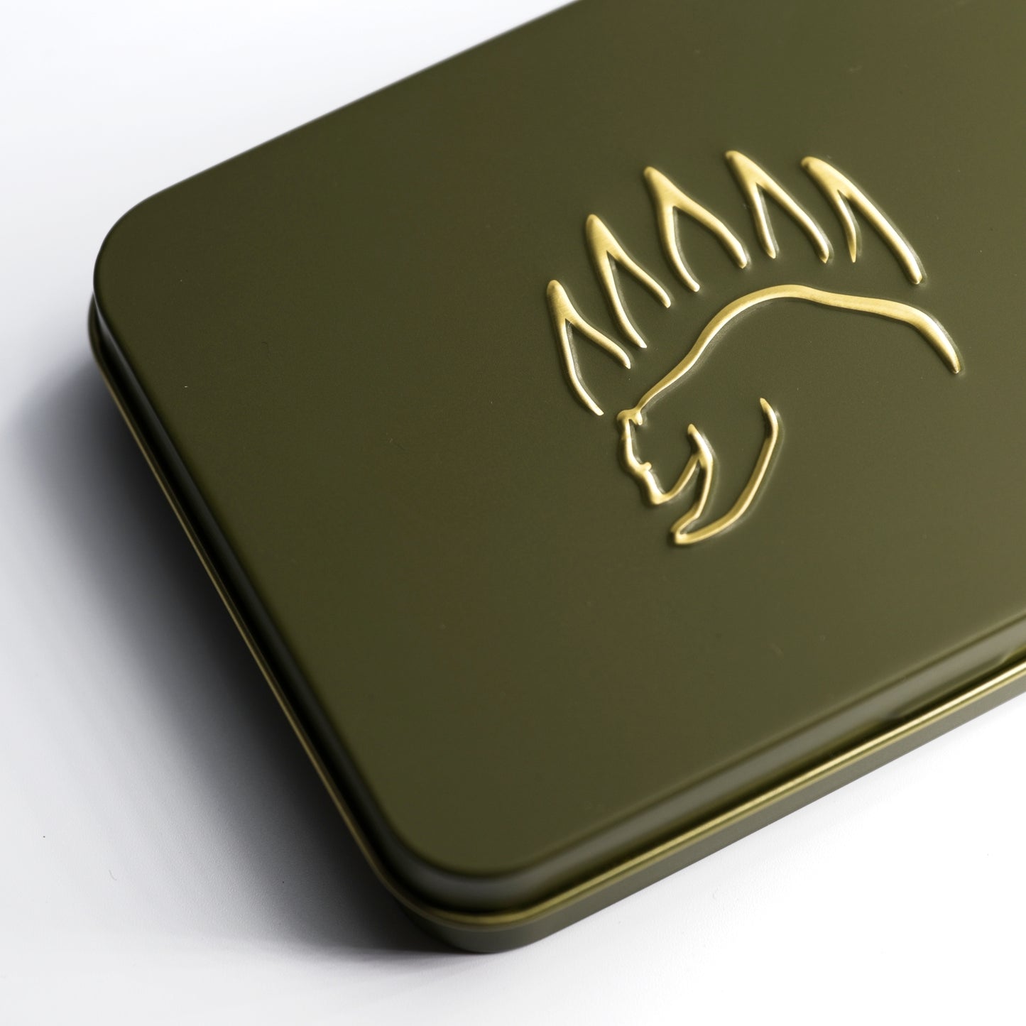 Close-up of The Bear Essentials Knot Tying Kit tin featuring embossed bear paw logo, designed for outdoor knot learning.
