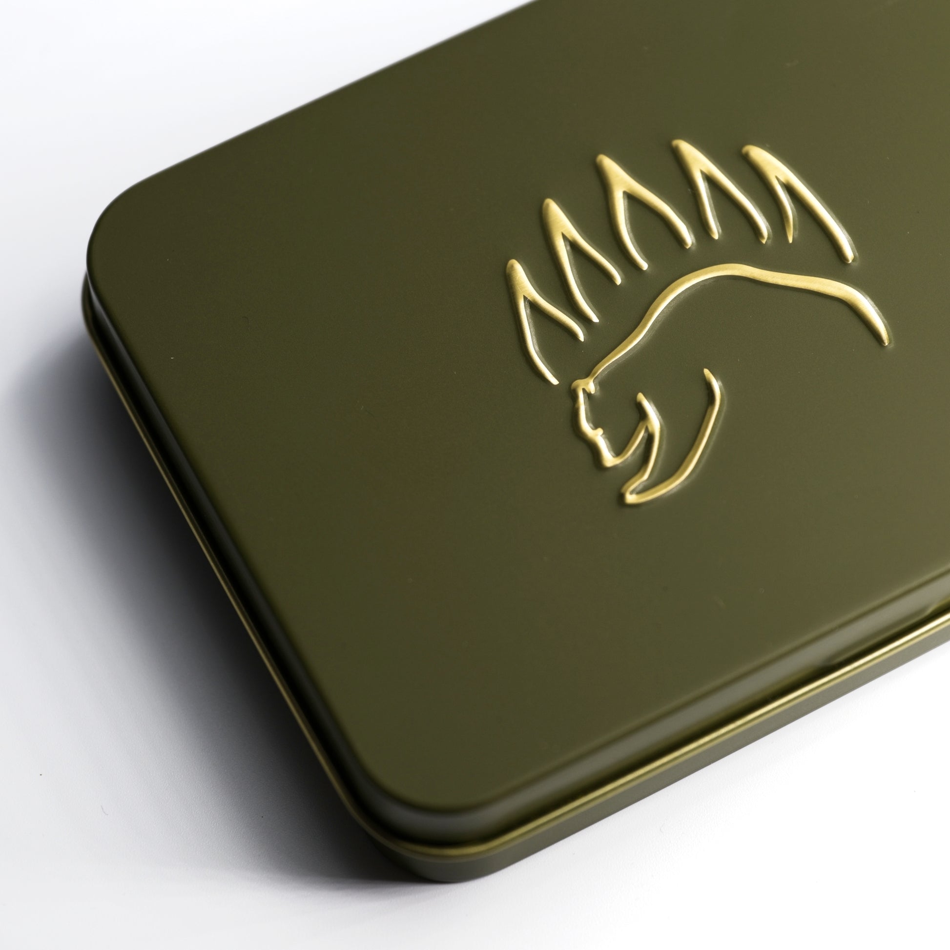 Close-up of The Bear Essentials Knot Tying Kit tin featuring embossed bear paw logo, designed for outdoor knot learning.