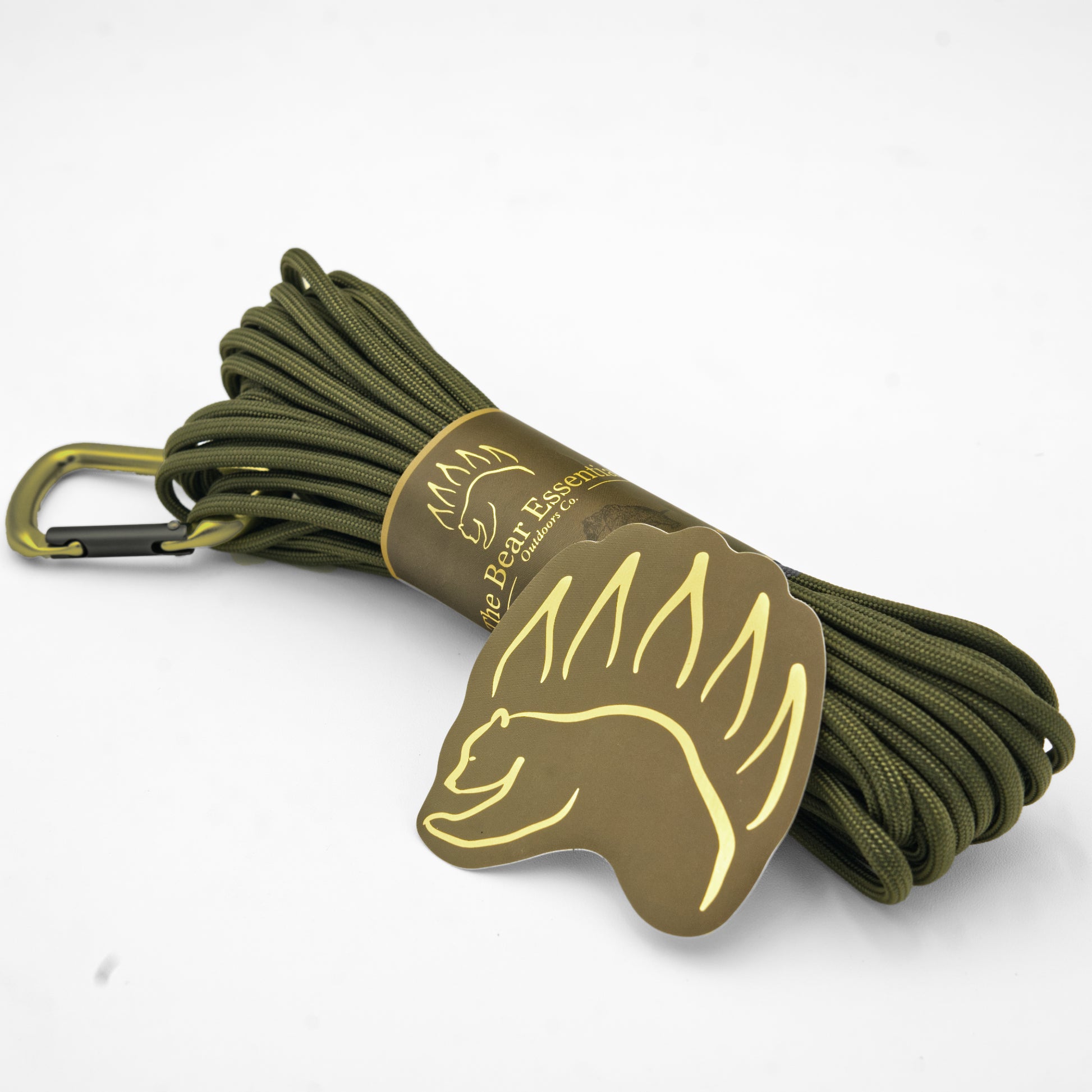 Olive green Bear Essentials Premium Bushcraft Paracord with gold bear logo tag, designed for outdoor use with 750lbs tensile strength.