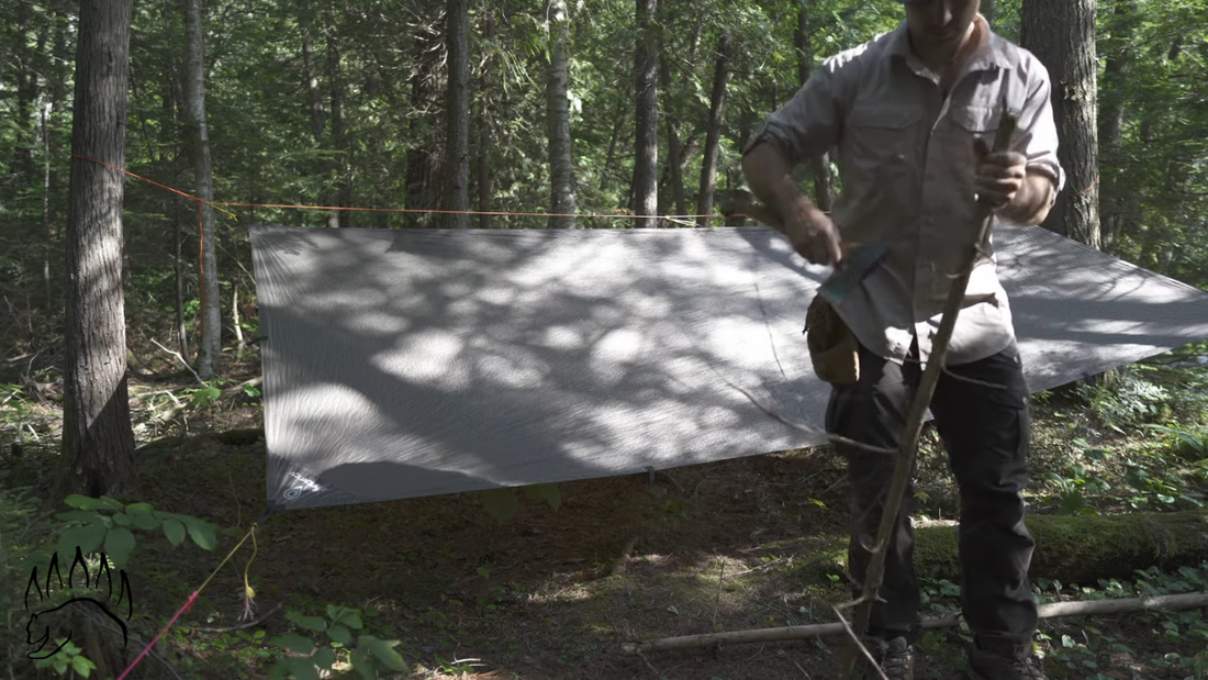 Camp: clearing branches with an ax or bucksaw