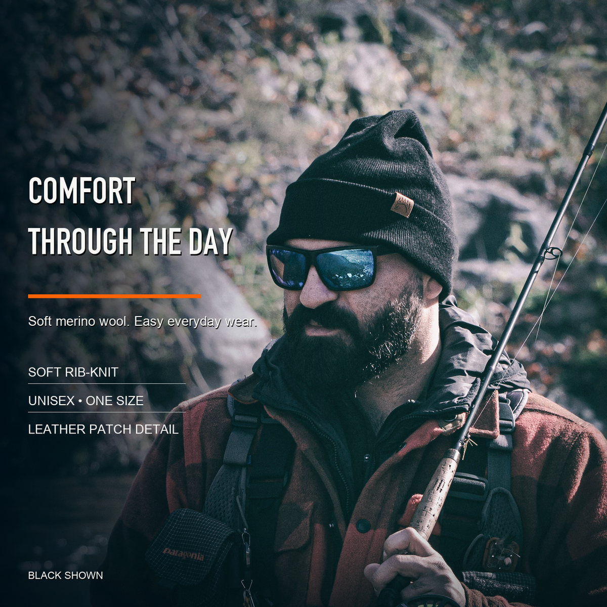man wearing black merino beanie while fly fishing