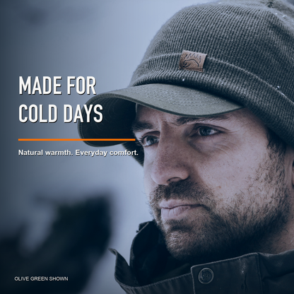Man wearing green merino beanie in the snow